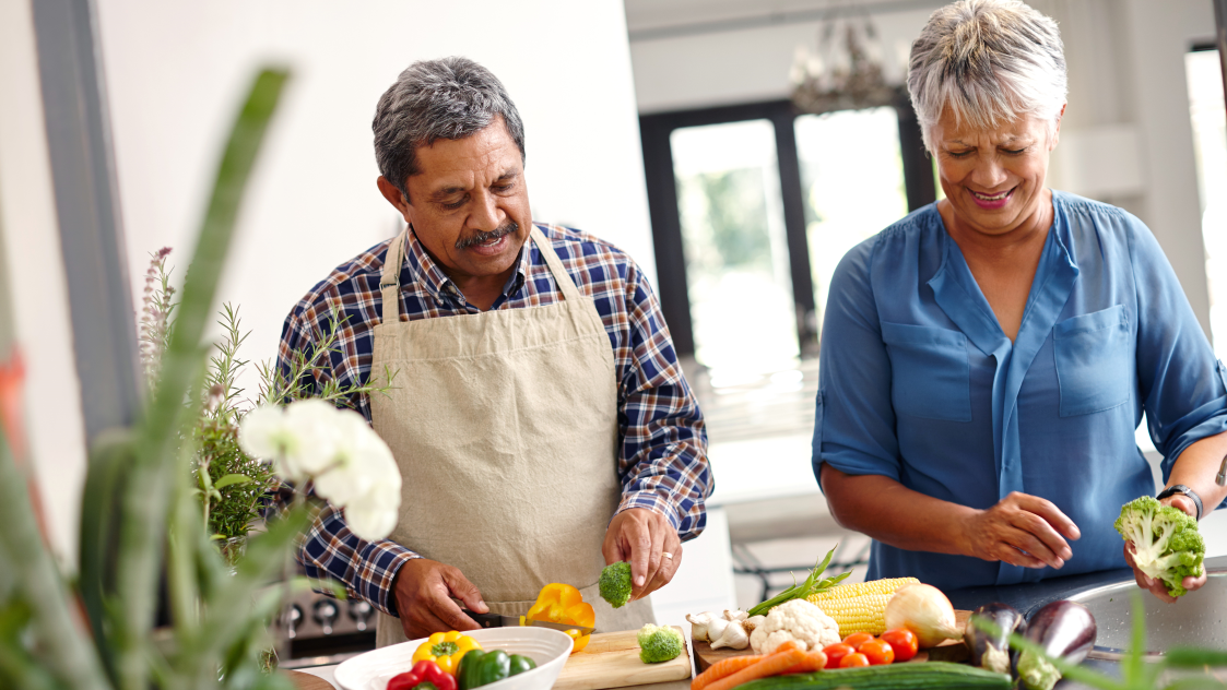 — title missing — Middle-aged couple cutting vegetables